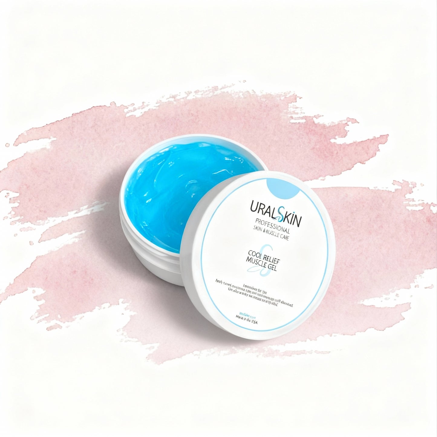 Open jar of URALSKIN Cool Relief Muscle Gel with bright blue gel on a white background with soft pink brushstrokes